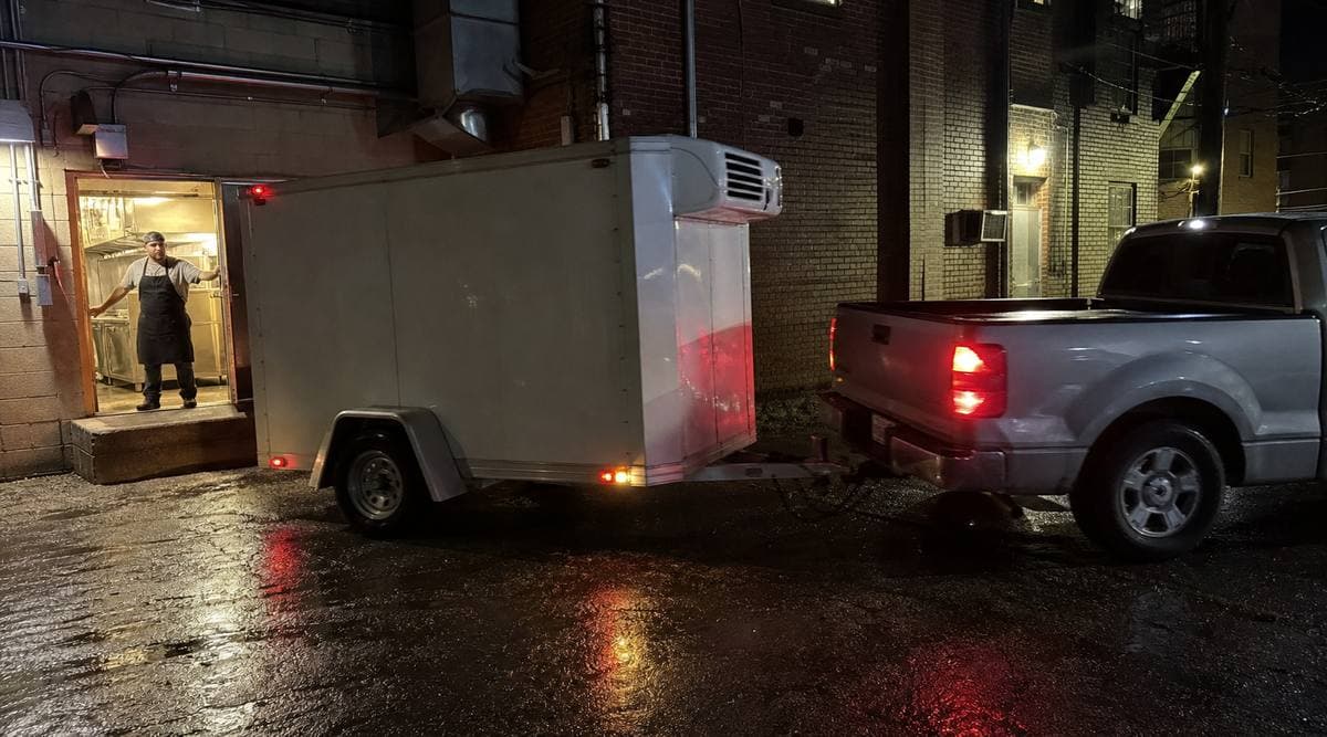 Mobile reefer trailer arriving at a restaurant's back entrance in Toronto